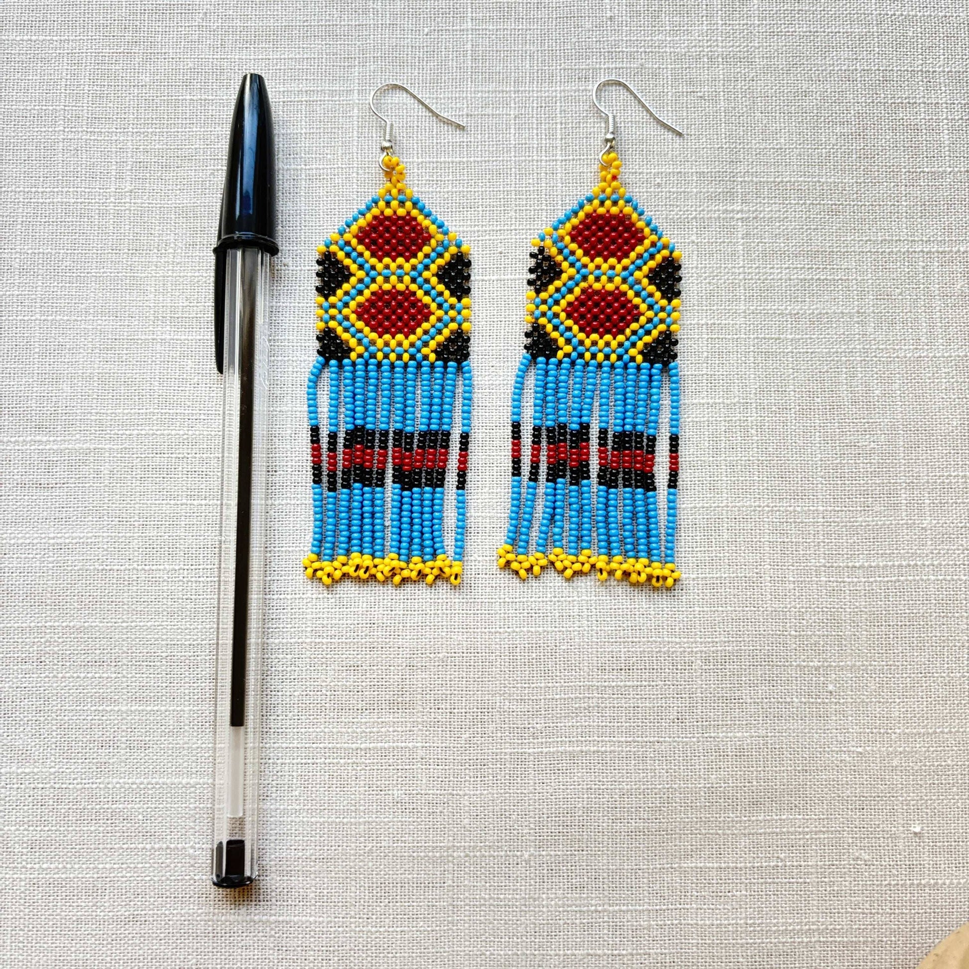 Boucles d'oreilles en perles de verre (miçanga) - bleu, marron et jaune - Ethnie Wai Wai Boucles d'oreilles Ethnie Wai Wai localisée dans les états de l' Amazonas, Pará et Roraima dans le Nord du Brésil. 