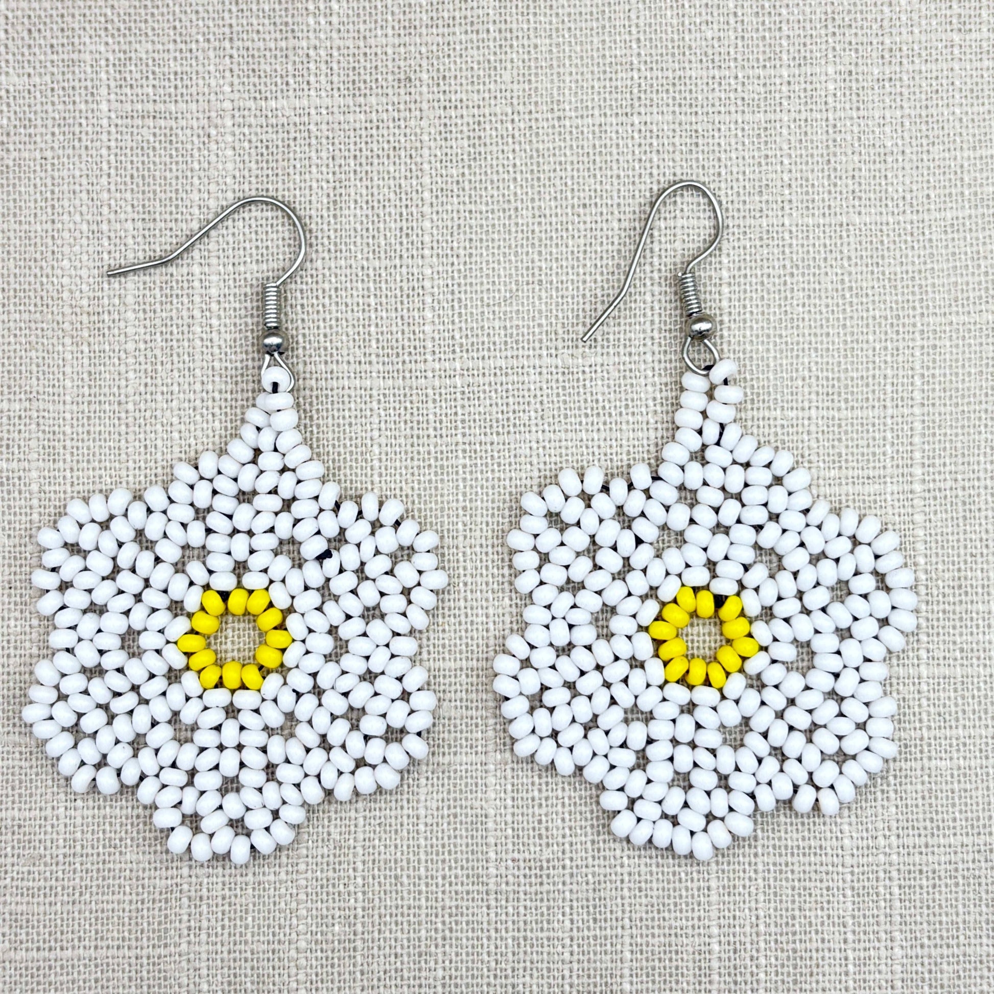 Boucles d'oreilles en perles de verre (miçanga) - Fleur blanche coeur jaune - Ethnie Wai Wai Boucles d'oreilles Ethnie Wai Wai localisée dans les états de l' Amazonas, Pará et Roraima dans le Nord du Brésil. 