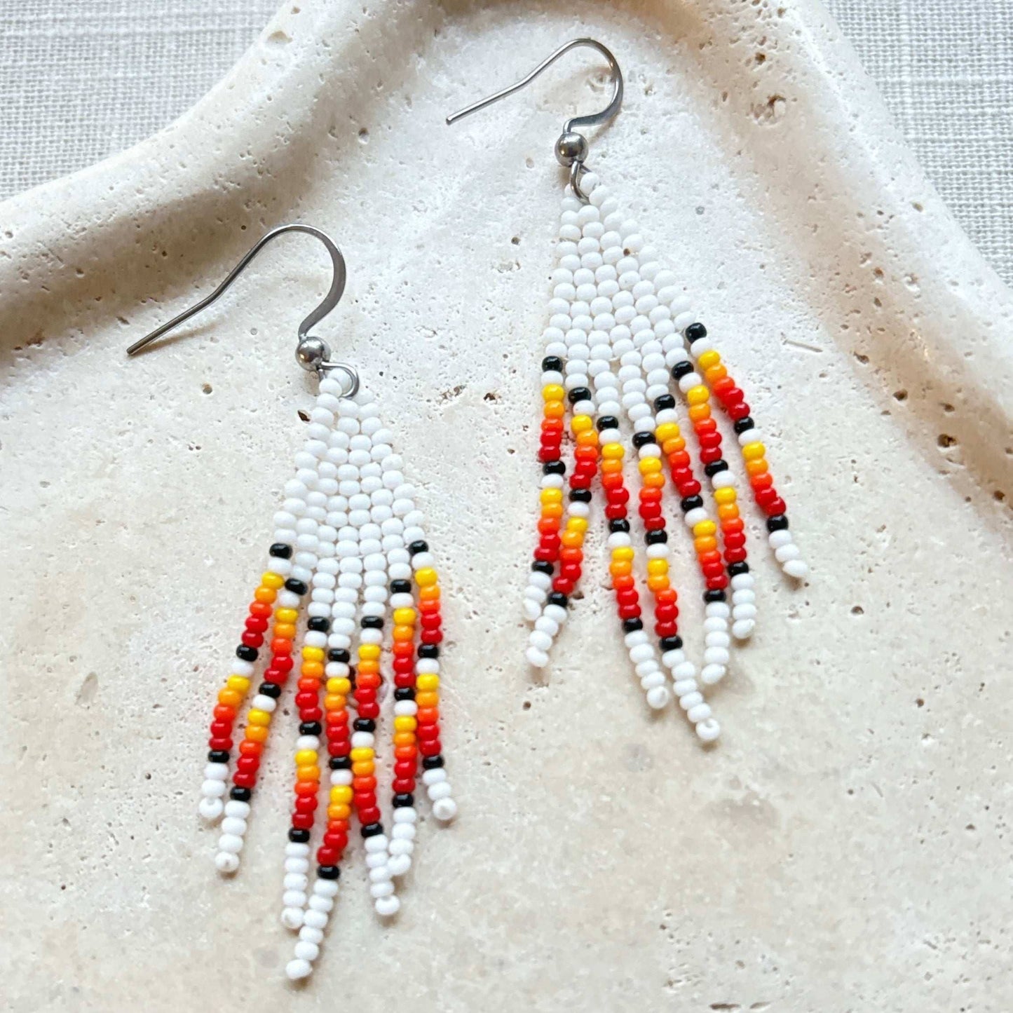 Boucles d'oreilles en perles de verre (Miçanga) - Franges blanc rouge orange - Ethnie Borari Boucles d'oreilles Ethnie Borari, localisée dans l'état du Pará dans le Nord du Brésil. 