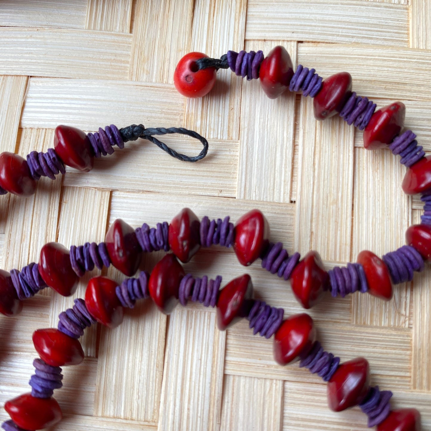 Collier de graines de morototo teintées violettes et graines de Pau Brasil Collier Communauté Jamaraqua, située sur la rive du fleuve Tapajos, état du Para. 